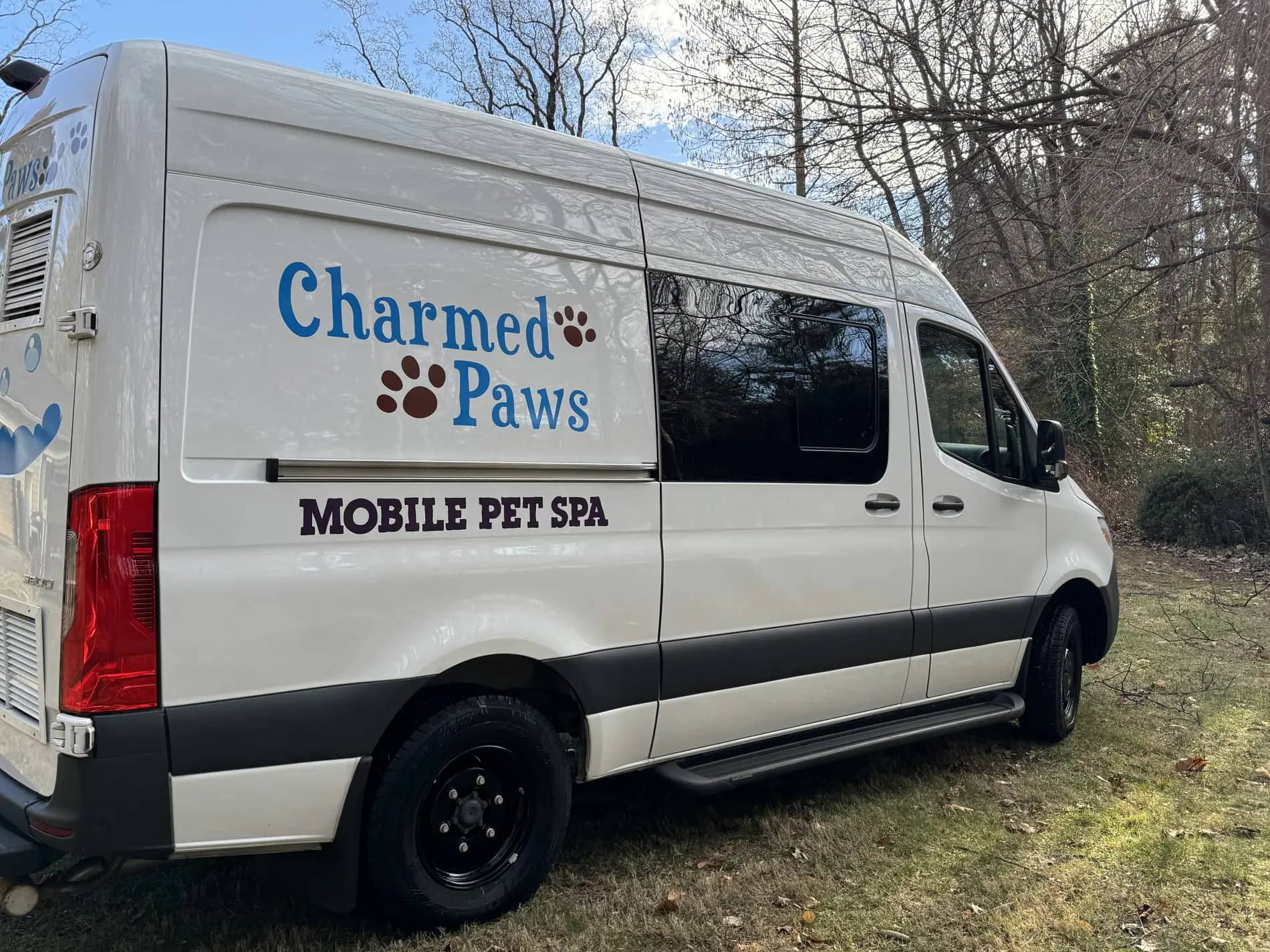 Charmed Paws Mobile Pet Spa grooming van parked for mobile service