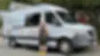 Doggy Dog World owner next to the mobile grooming van